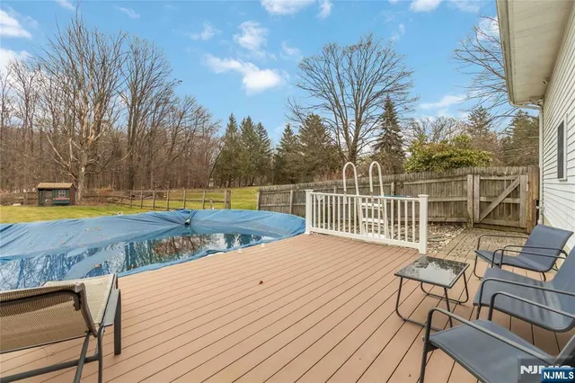 a view of a roof deck with couches and wooden floor