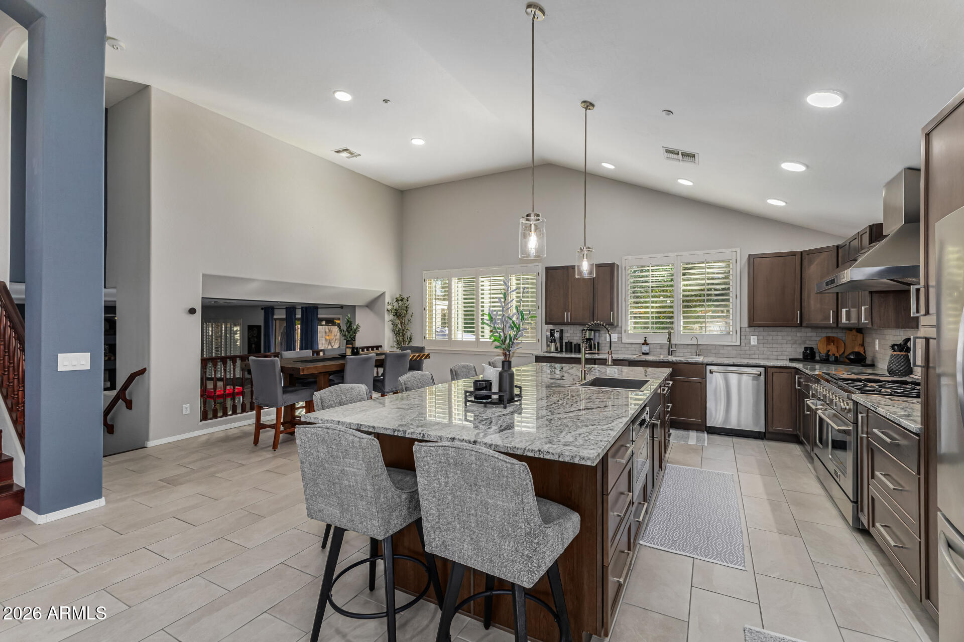 6829 West Briles Road Peoria, AZ 85383 - Photo 12 of 61 a large kitchen with a table and chairs