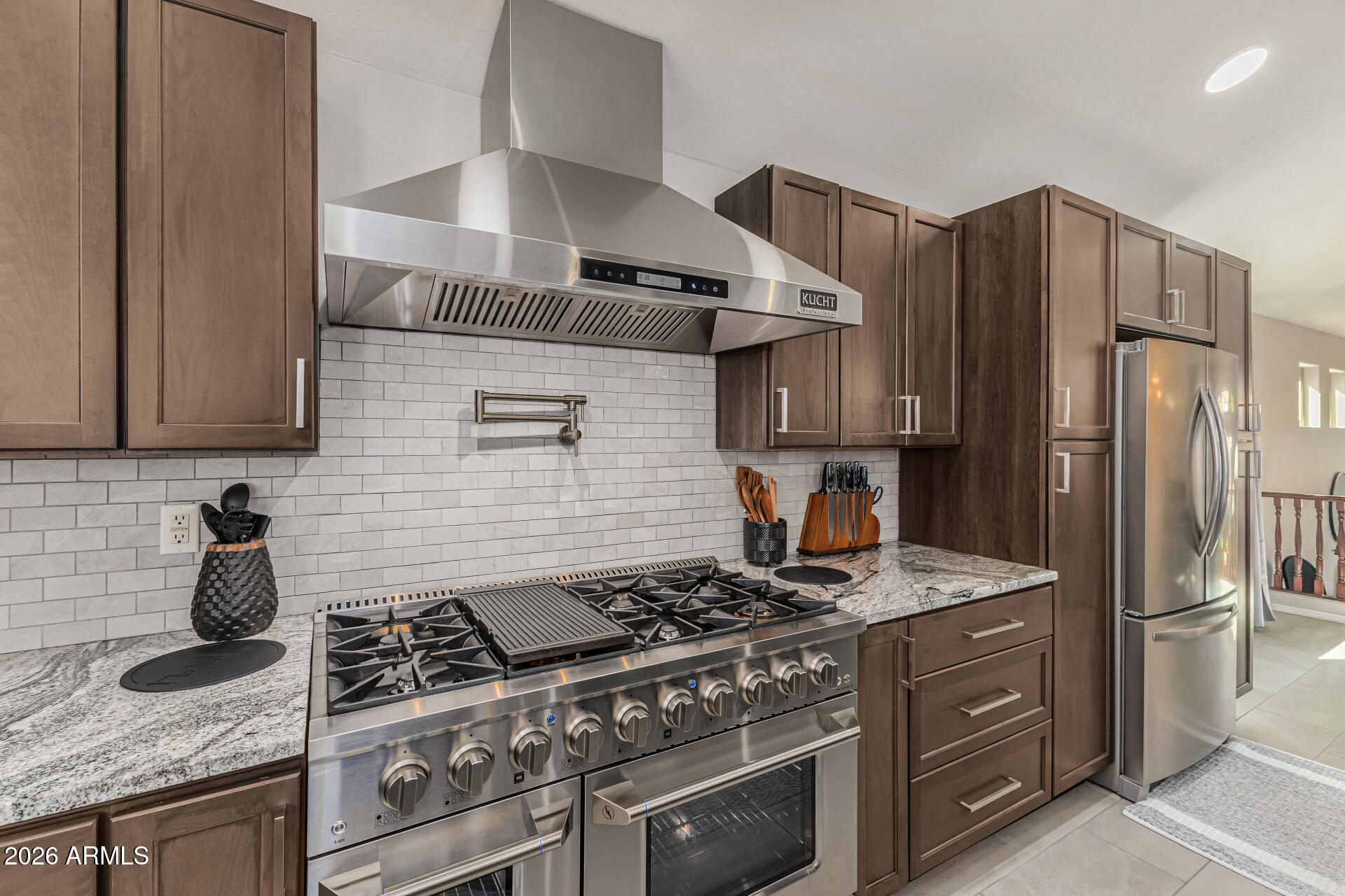 6829 West Briles Road Peoria, AZ 85383 - Photo 17 of 61 a kitchen with granite countertop a stove and a refrigerator