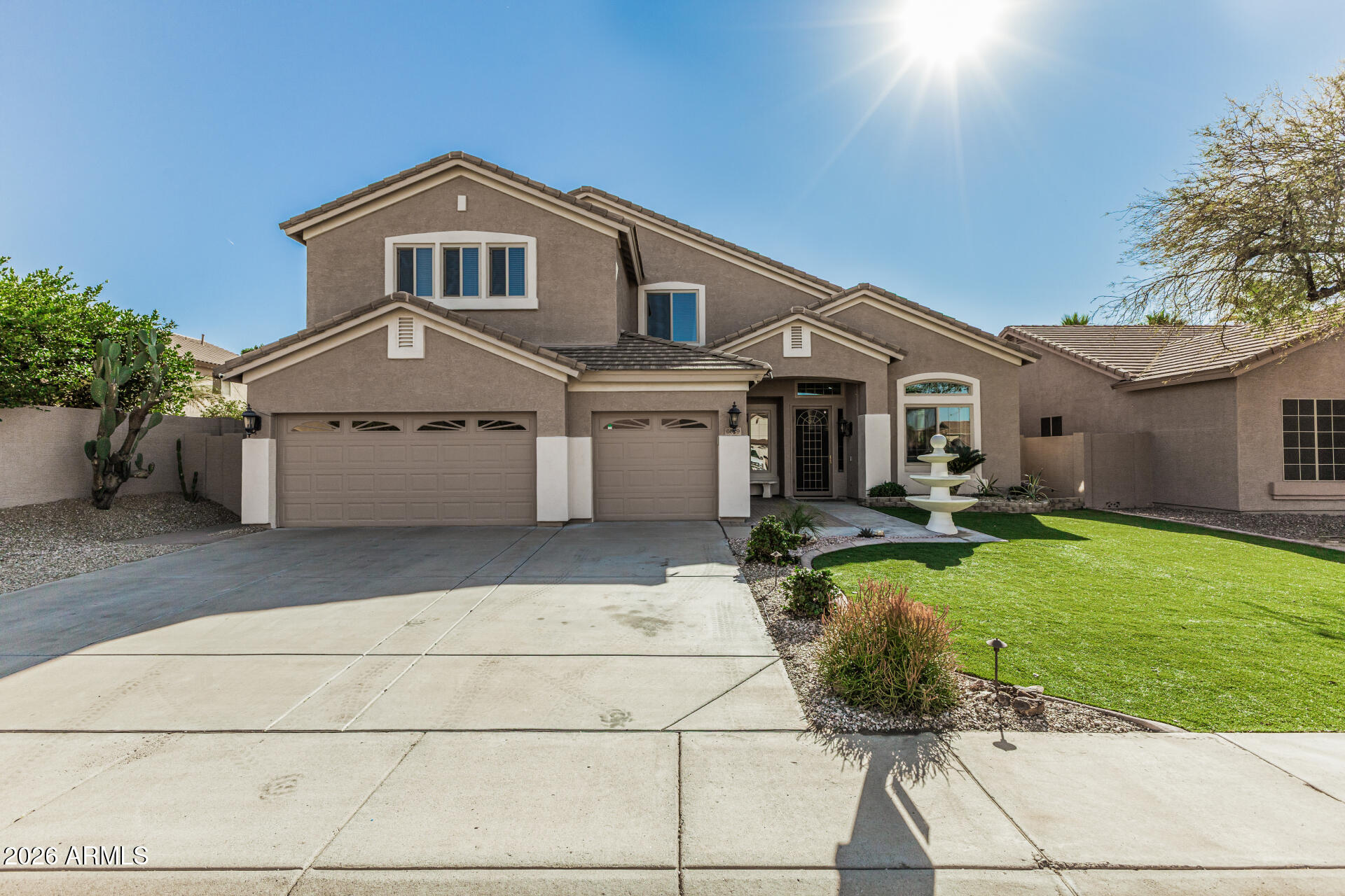 6829 West Briles Road Peoria, AZ 85383 - Photo 2 of 61 a front view of a house with garden