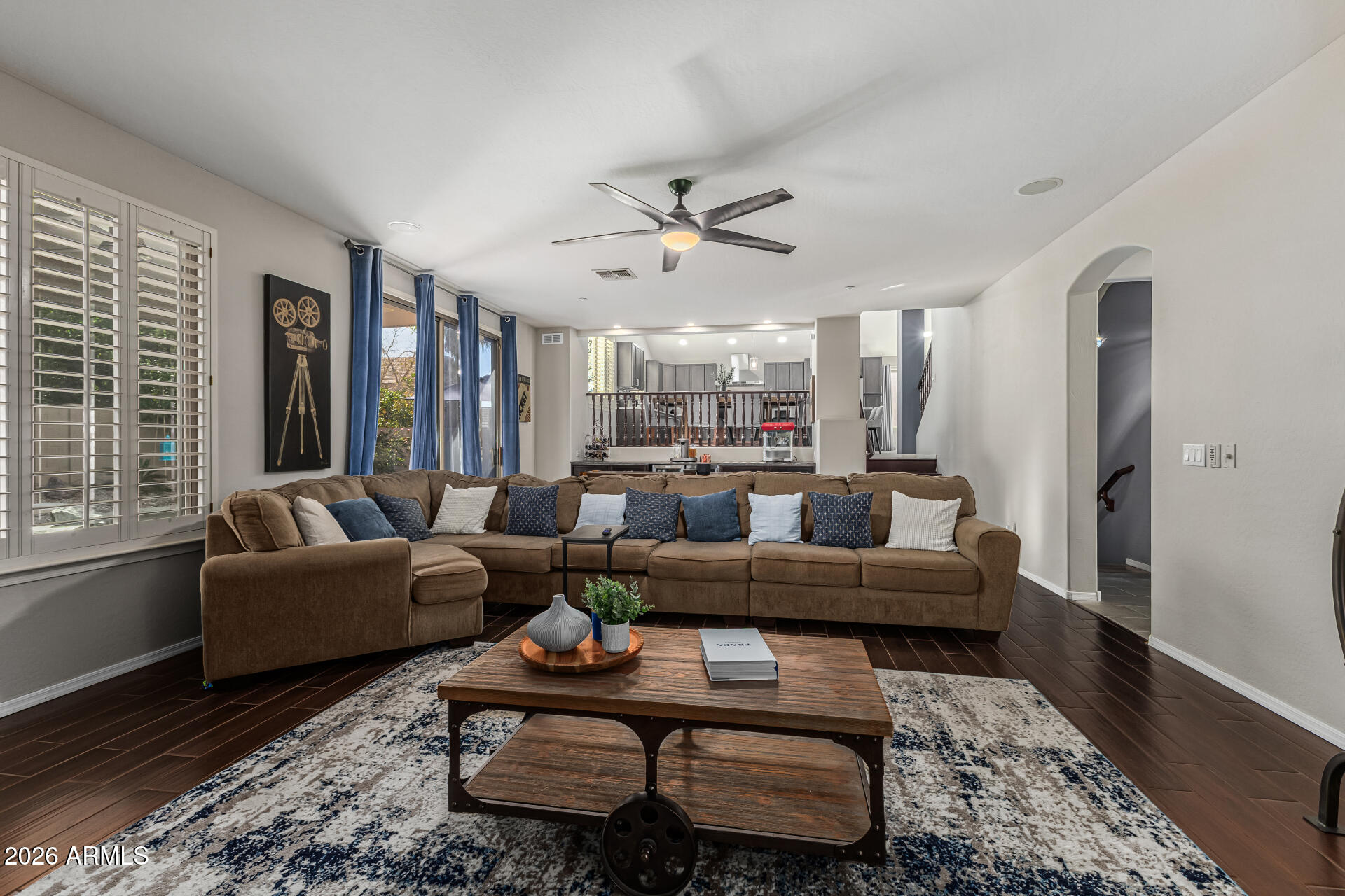 6829 West Briles Road Peoria, AZ 85383 - Photo 24 of 61 a living room with furniture ceiling fan and a rug
