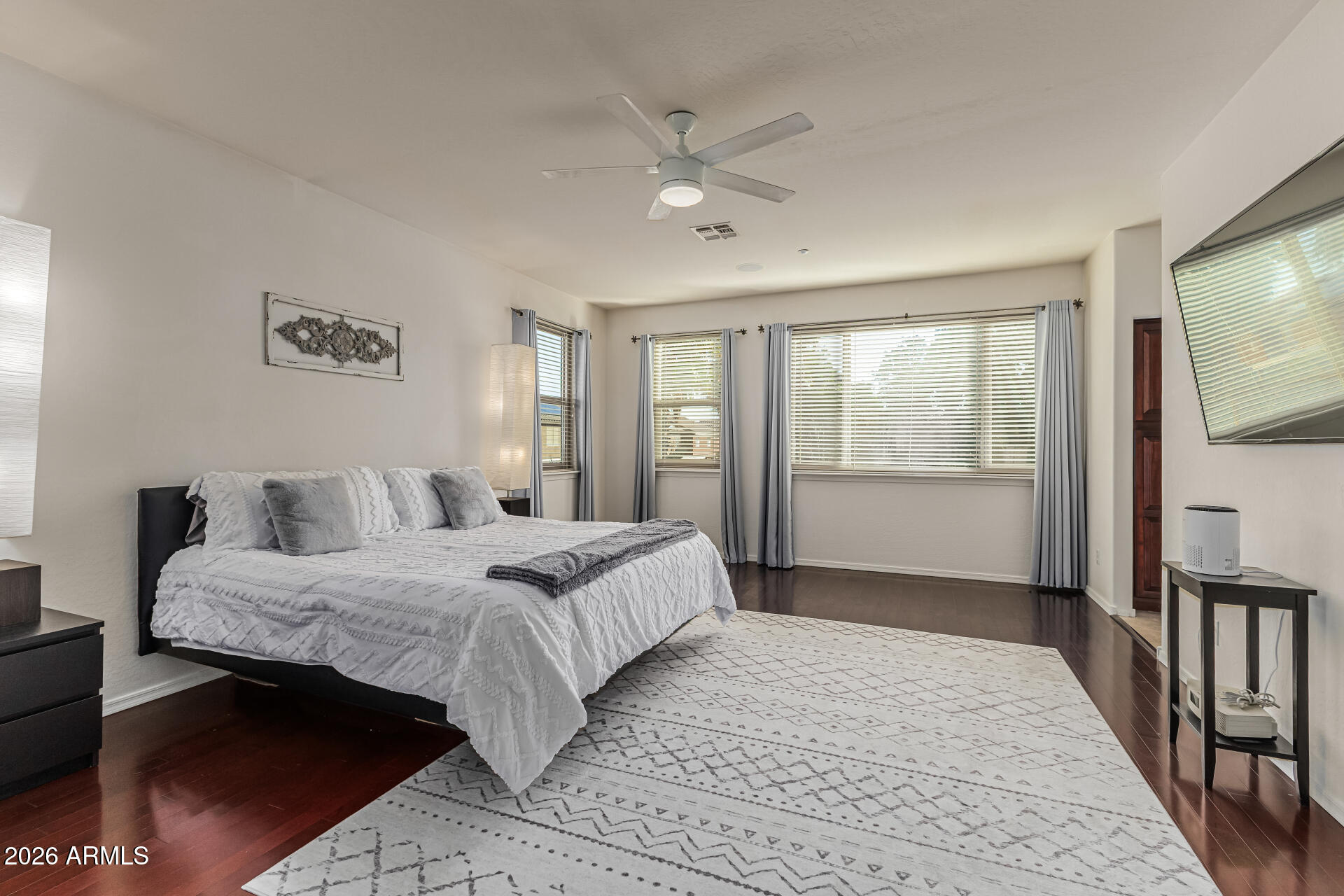 6829 West Briles Road Peoria, AZ 85383 - Photo 27 of 61 a bedroom with a large bed and a flat tv screen on dresser