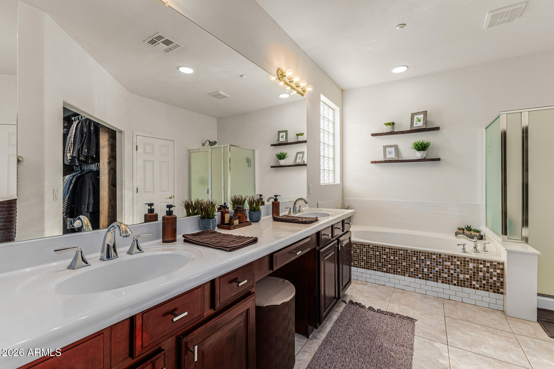 6829 West Briles Road Peoria, AZ 85383 - Photo 28 of 61 a bathroom with a double vanity sink mirror and bathtub