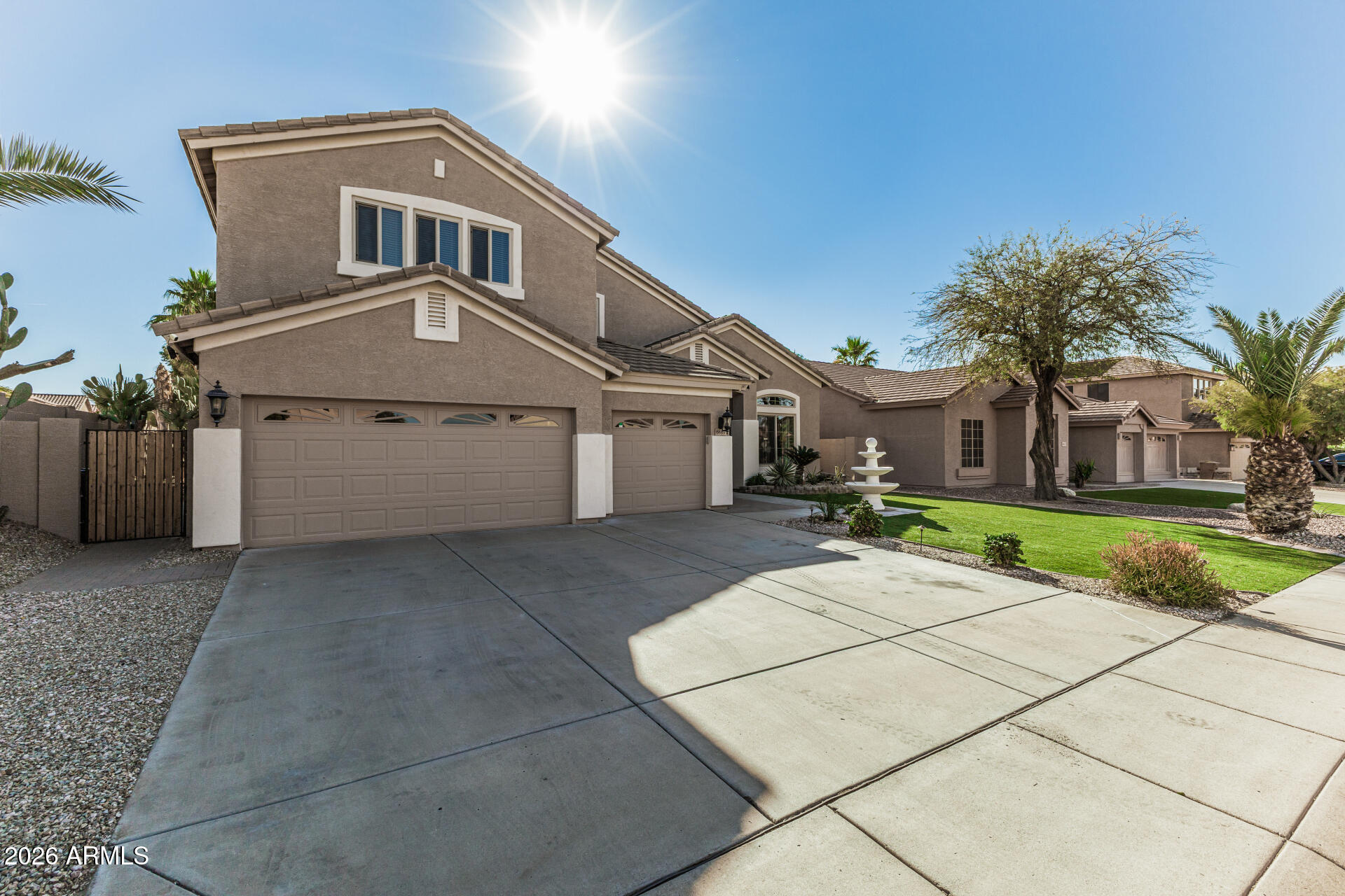 6829 West Briles Road Peoria, AZ 85383 - Photo 3 of 61 a front view of a house with a yard and garage