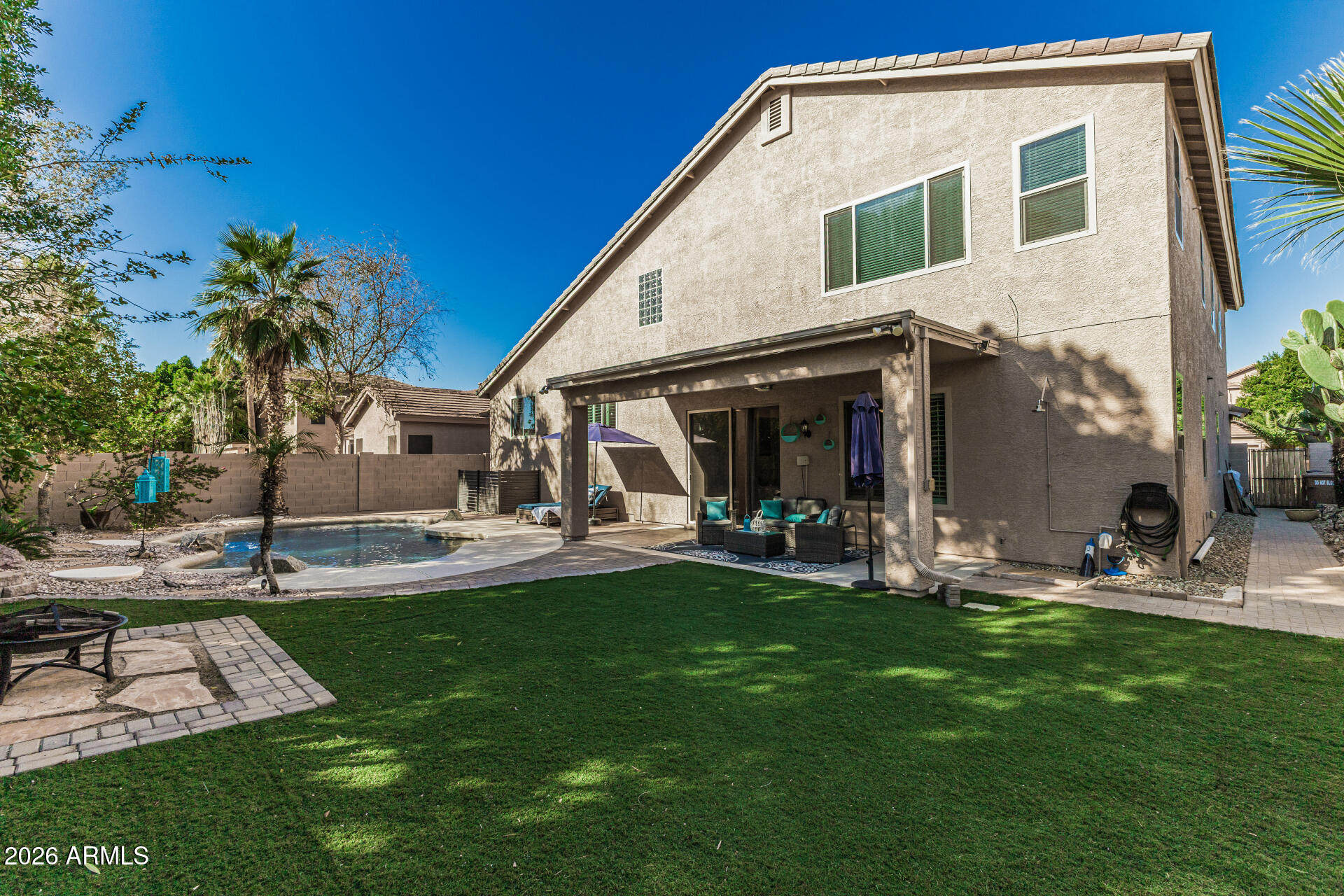 6829 West Briles Road Peoria, AZ 85383 - Photo 47 of 61 a view of a house with backyard sitting area and garden