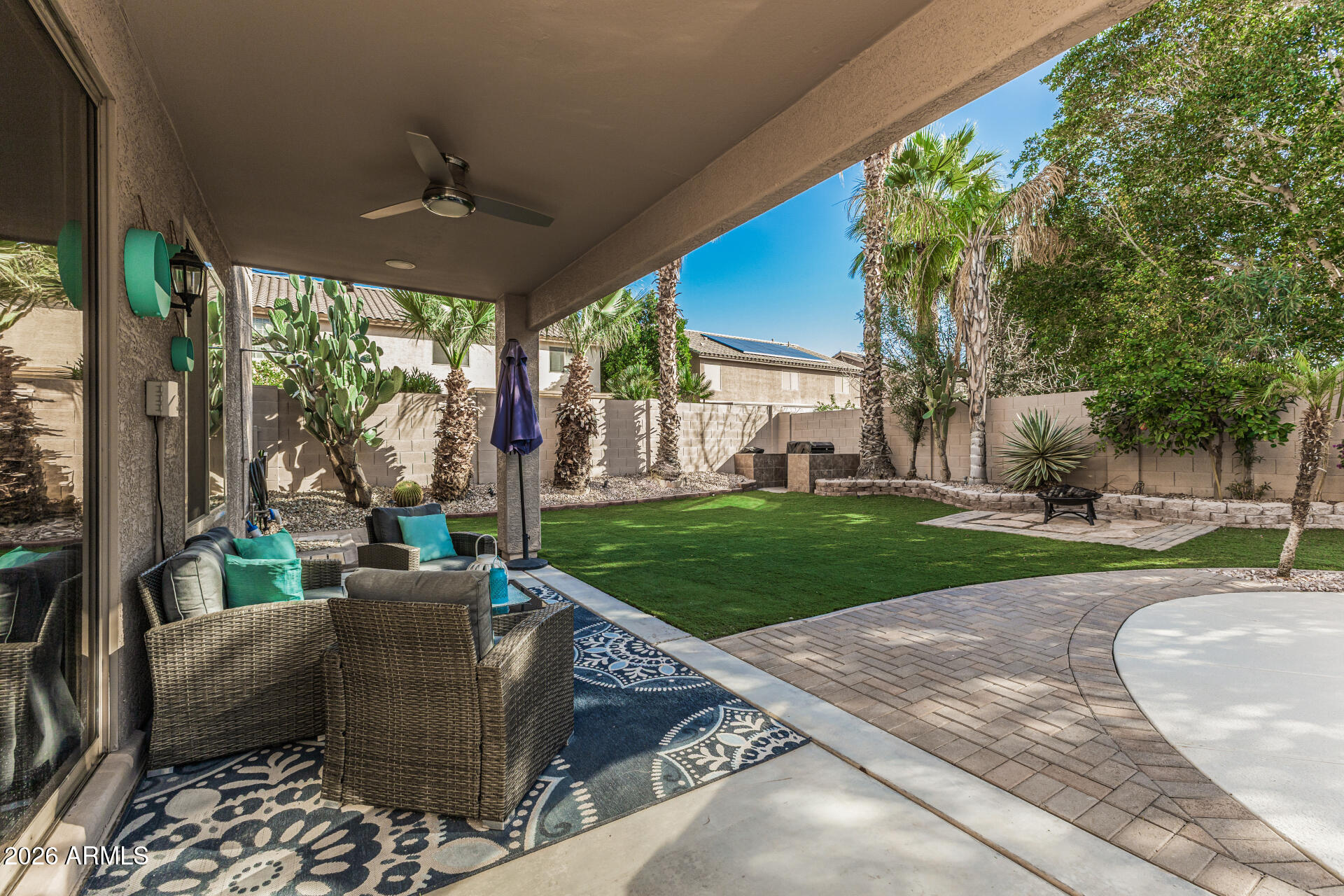 6829 West Briles Road Peoria, AZ 85383 - Photo 53 of 61 a view of a patio with a table chairs and a yard