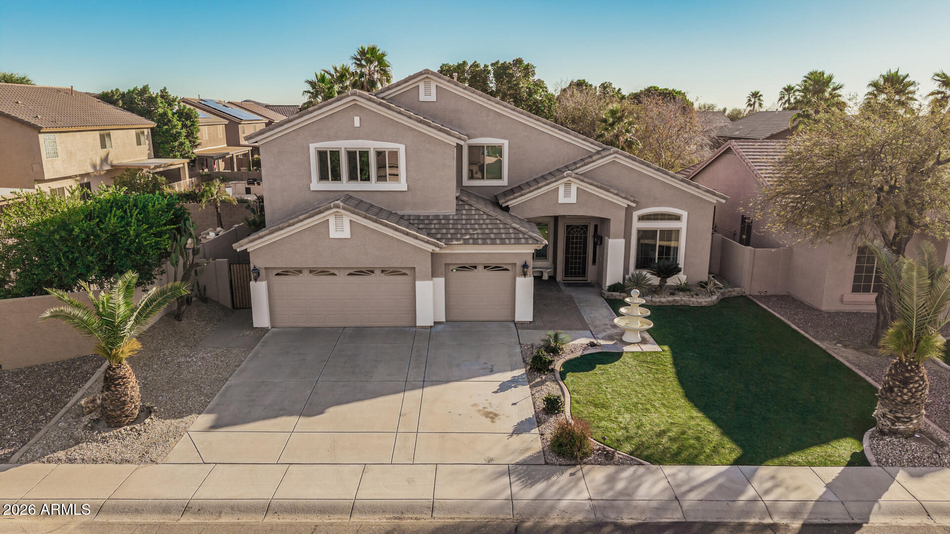 6829 West Briles Road Peoria, AZ 85383 - Photo 58 of 61 a view of a white house next to a yard with big trees