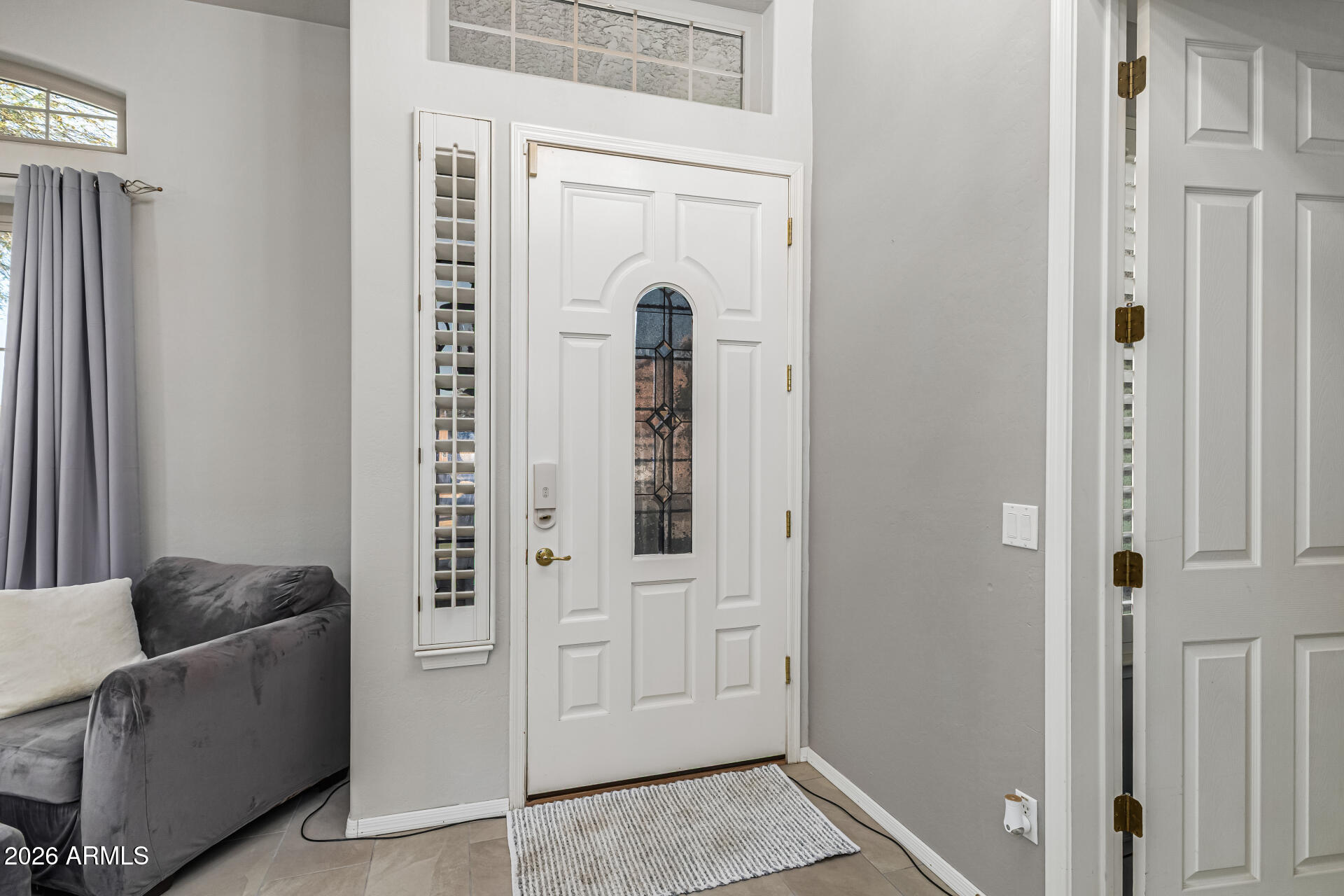 6829 West Briles Road Peoria, AZ 85383 - Photo 7 of 61 a living room with furniture and a door