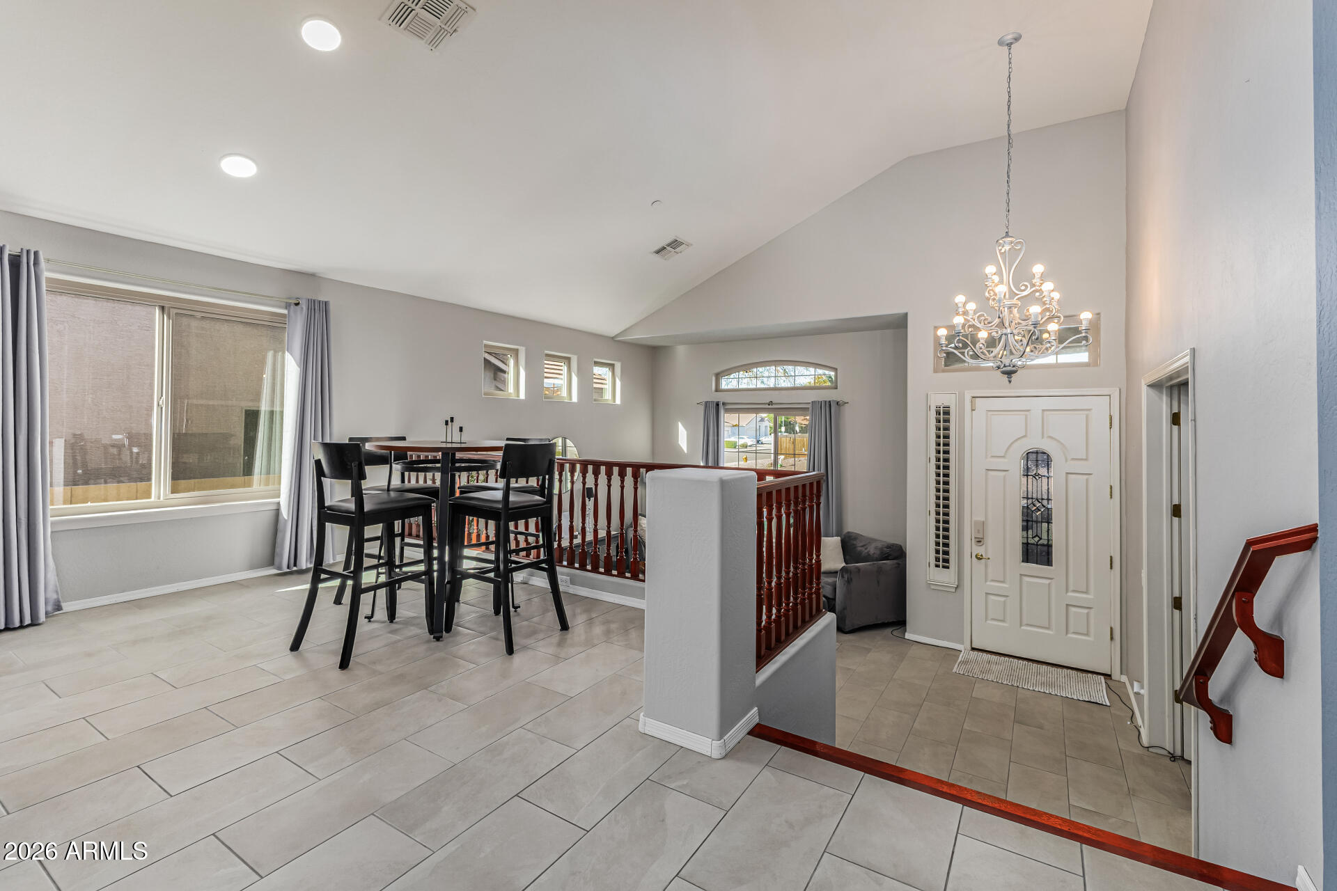 6829 West Briles Road Peoria, AZ 85383 - Photo 10 of 61 a view of a dining room with furniture and a chandelier
