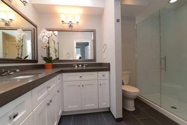 Undisclosed Address Chicago, IL 60614 - Photo 10 of 17 a bathroom with a granite countertop sink a toilet and a mirror
