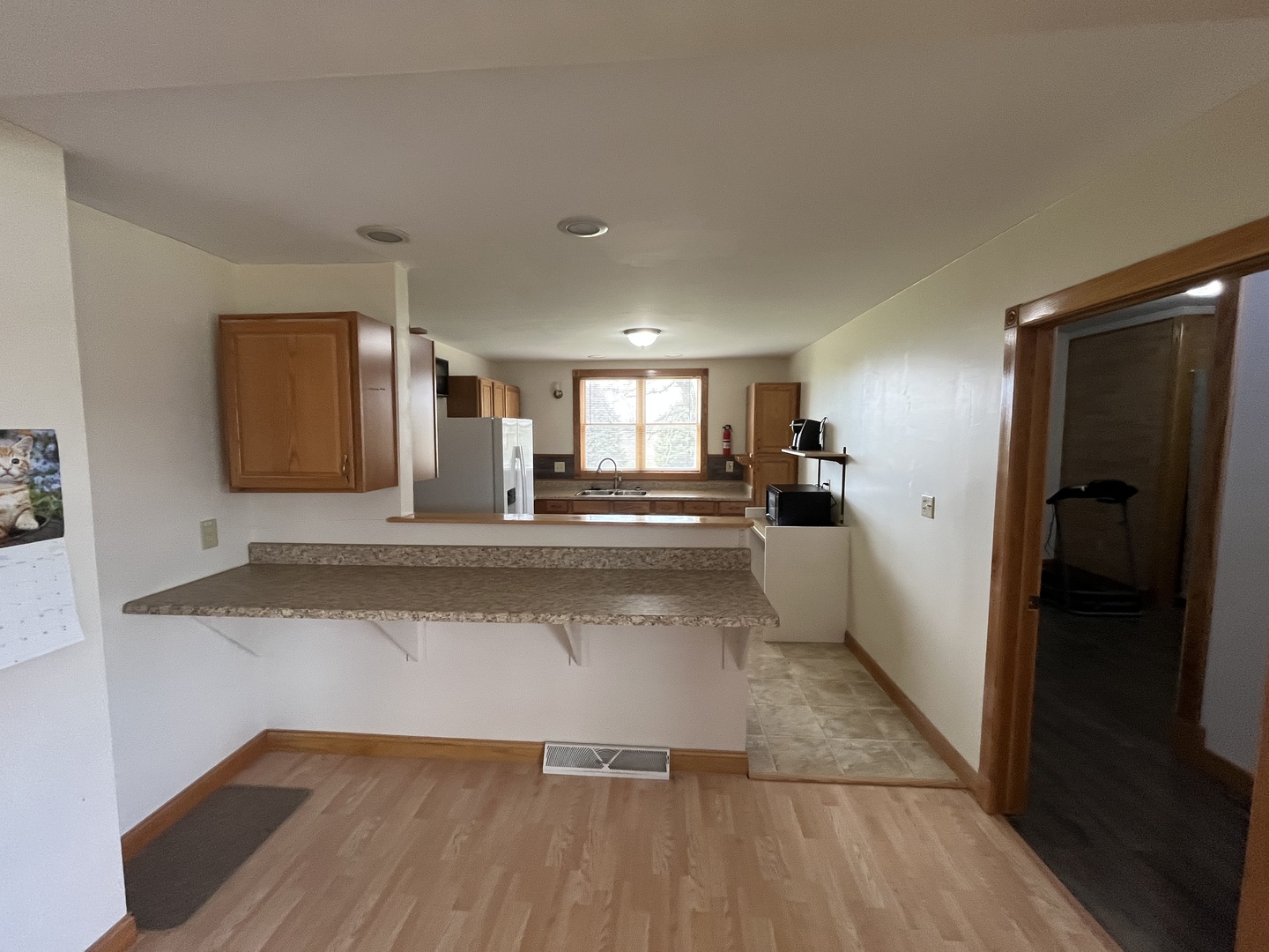 3420 Howlett Road Paw Paw, IL 61353 - Photo 11 of 34 a view of a hallway with wooden floor and a living room
