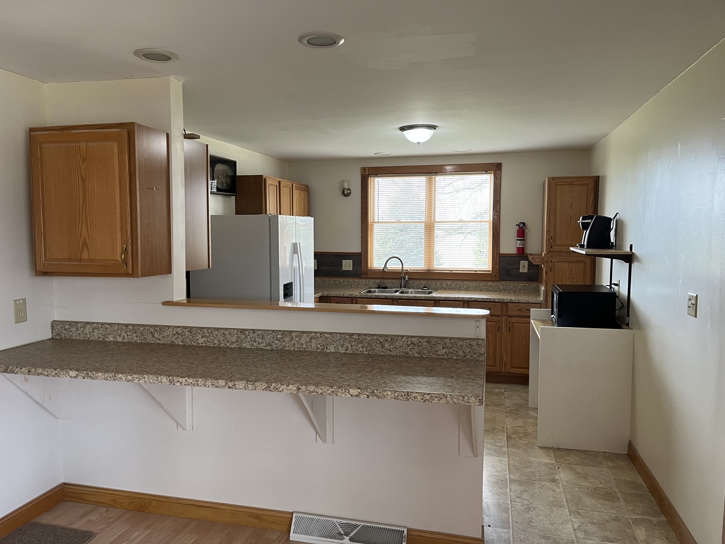 3420 Howlett Road Paw Paw, IL 61353 - Photo 12 of 34 a kitchen with a refrigerator and a sink