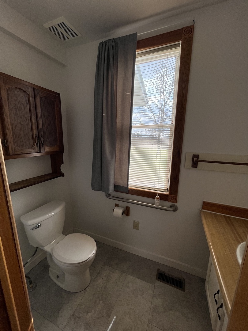 3420 Howlett Road Paw Paw, IL 61353 - Photo 24 of 34 a white toilet sitting next to a window in a bathroom