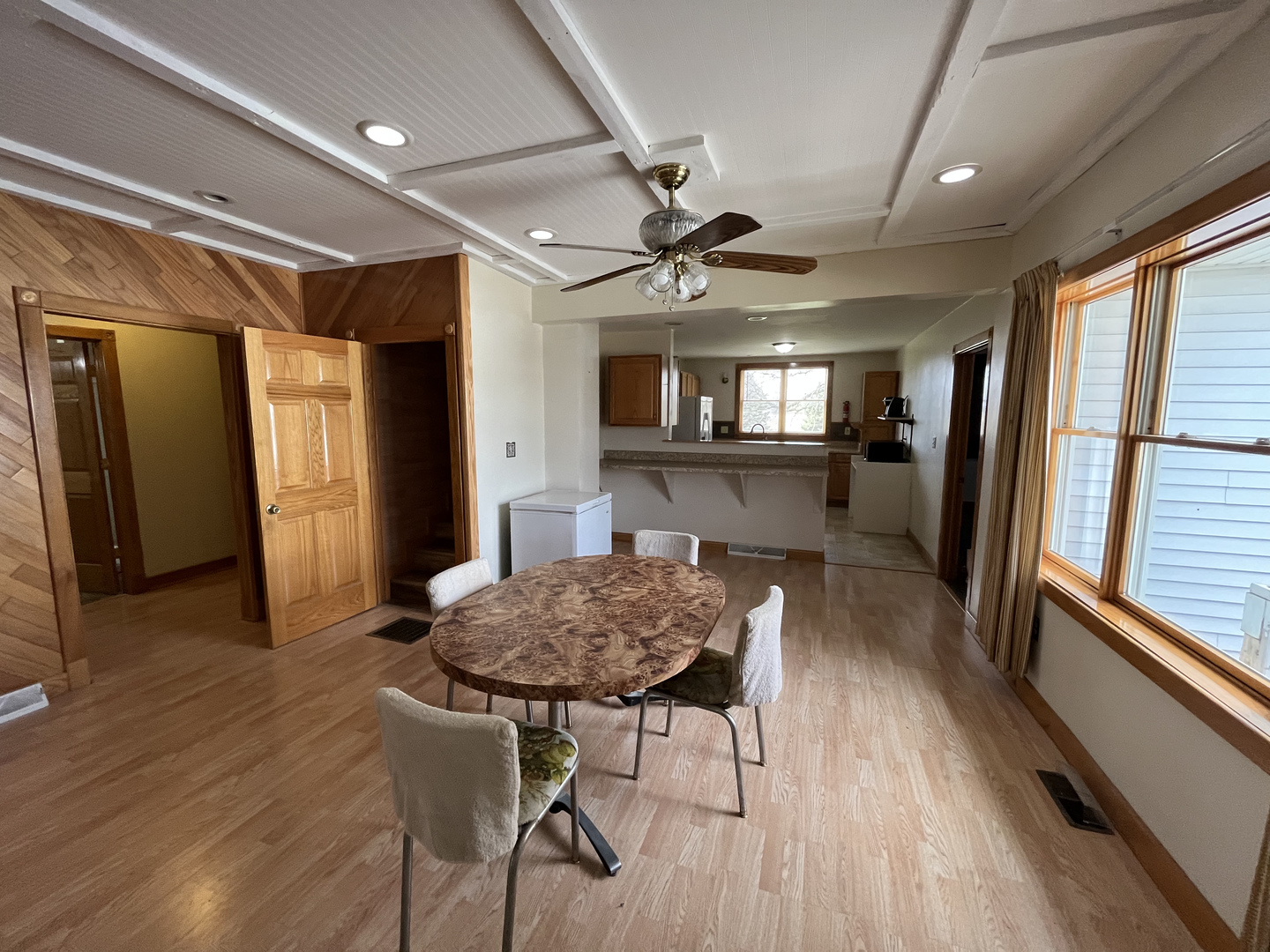 3420 Howlett Road Paw Paw, IL 61353 - Photo 8 of 34 a view of a kitchen with dining area a sink wooden floor and a window