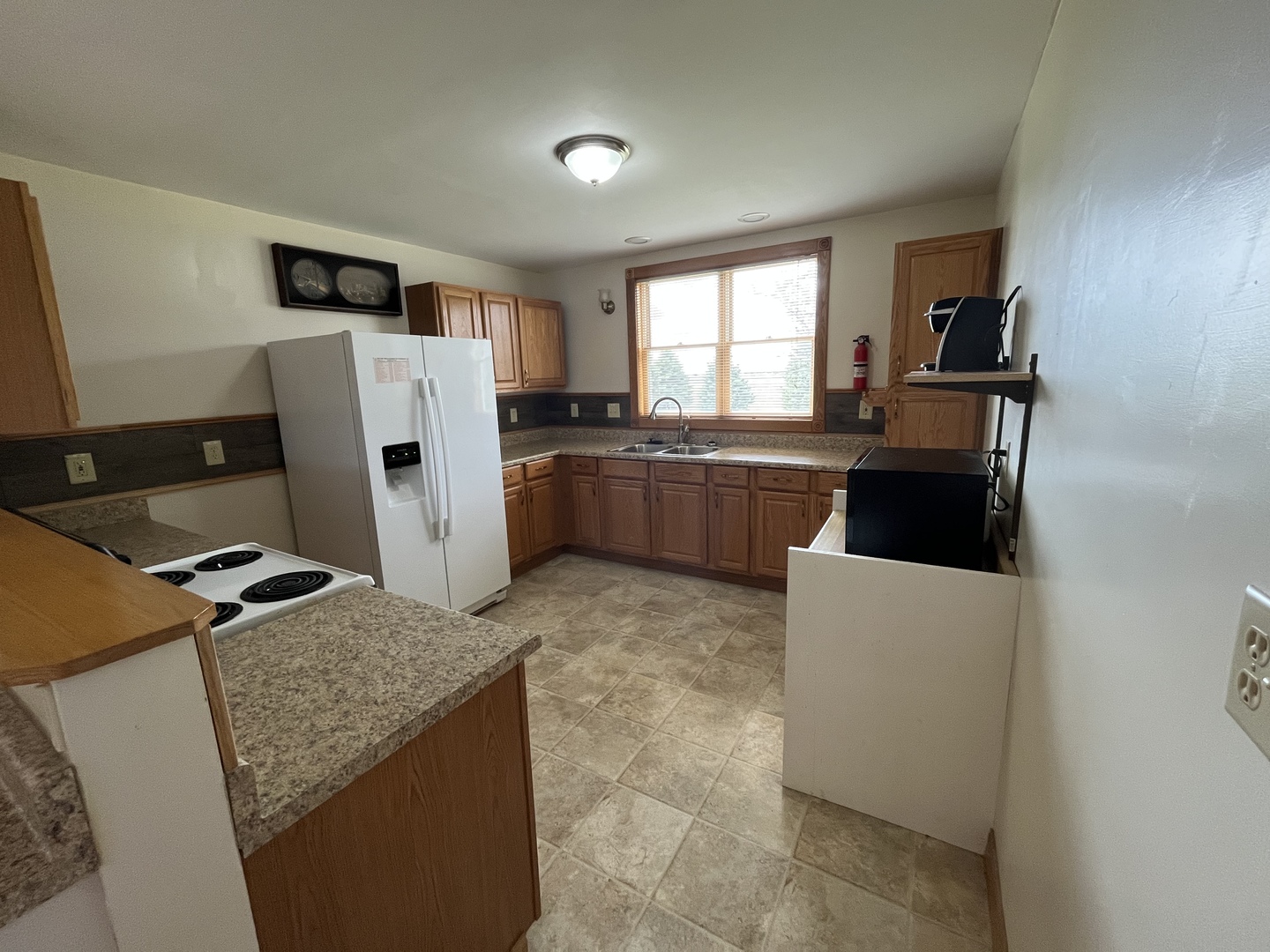3420 Howlett Road Paw Paw, IL 61353 - Photo 10 of 34 a kitchen with refrigerator and window