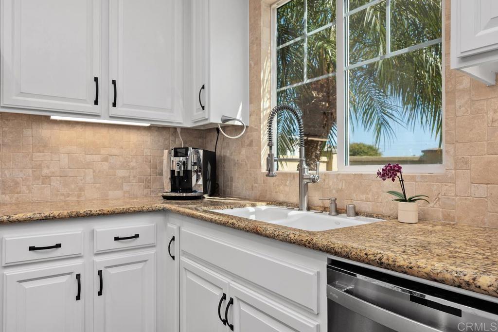 923 Citrine Way San Marcos, CA 92078 - Photo 11 of 47 a kitchen with granite countertop a sink and cabinets