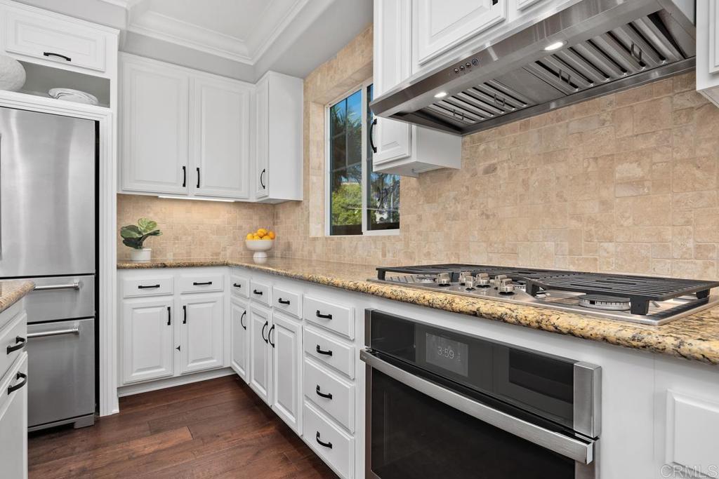 923 Citrine Way San Marcos, CA 92078 - Photo 12 of 47 a kitchen with granite countertop cabinets stainless steel appliances and wooden floor