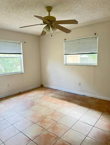 a view of a room that has a window and a fan
