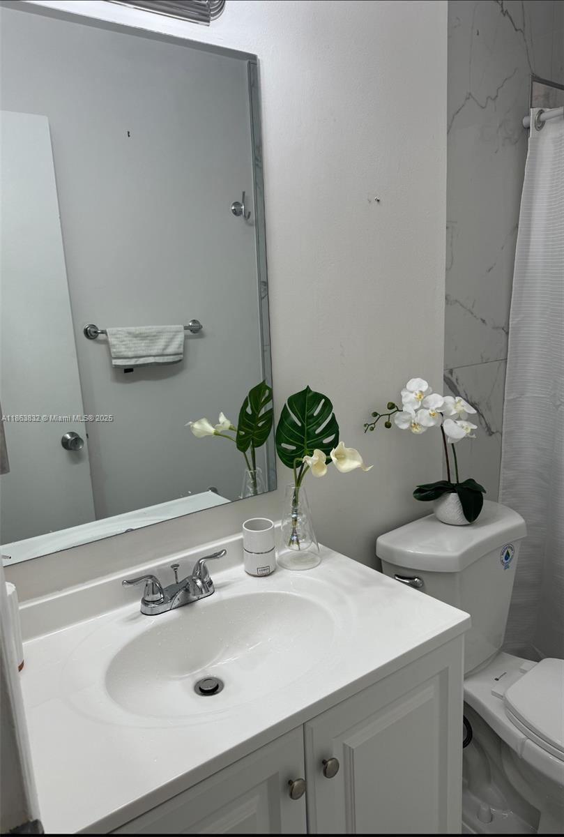 1327 Riverside Circle, Unit 1327 Wellington, FL 33414 - Photo 14 of 20 a bathroom with a sink and a mirror