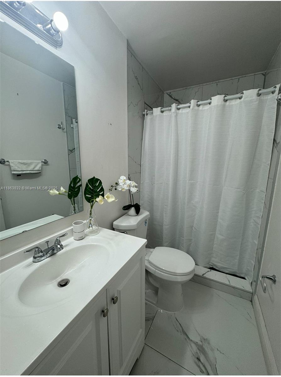 1327 Riverside Circle, Unit 1327 Wellington, FL 33414 - Photo 15 of 20 a bathroom with a sink toilet and shower