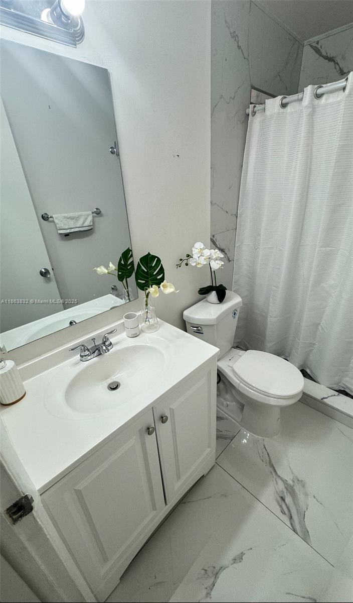 1327 Riverside Circle, Unit 1327 Wellington, FL 33414 - Photo 16 of 20 a bathroom with a sink toilet and shower