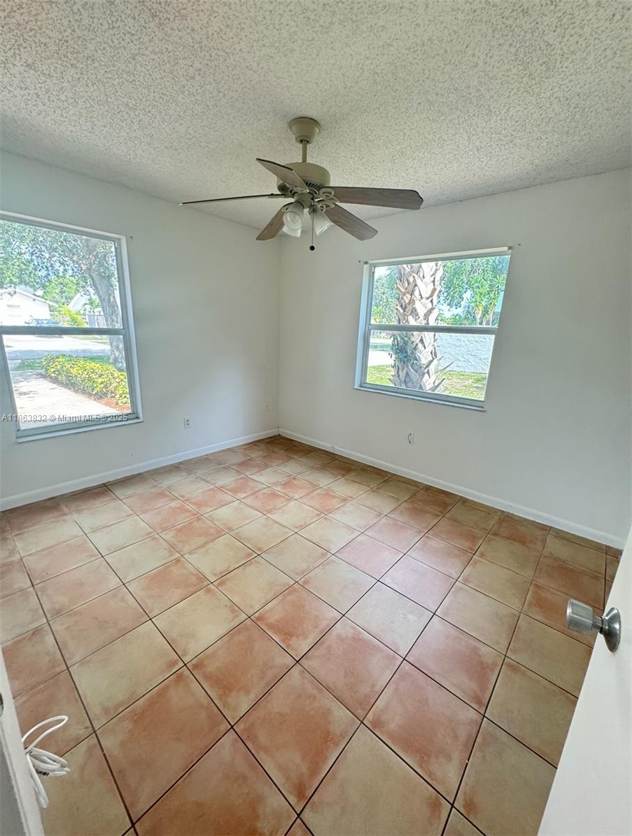 1327 Riverside Circle, Unit 1327 Wellington, FL 33414 - Photo 6 of 20 an empty room with windows and fan