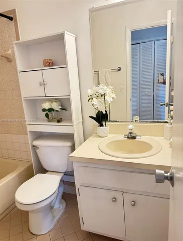 a bathroom with a sink toilet and mirror