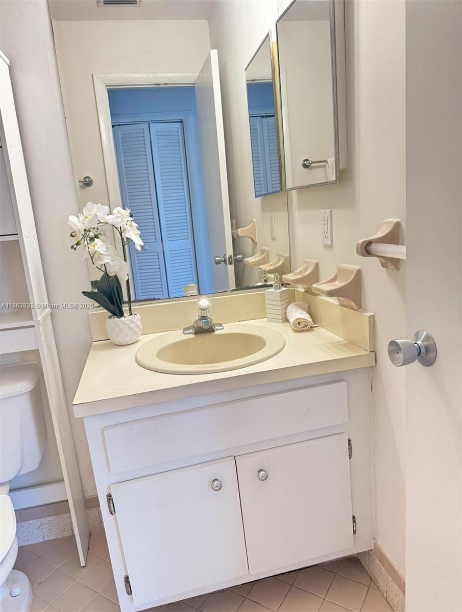 1327 Riverside Circle, Unit 1327 Wellington, FL 33414 - Photo 9 of 20 a bathroom with a sink and a mirror