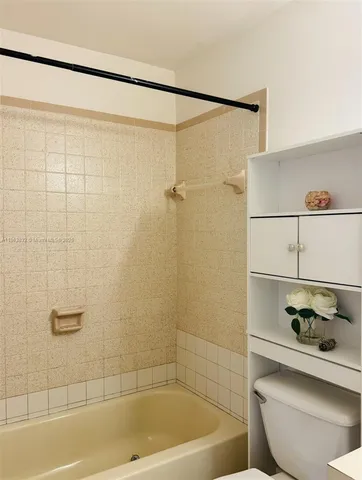 a bathroom with a shower and a toilet