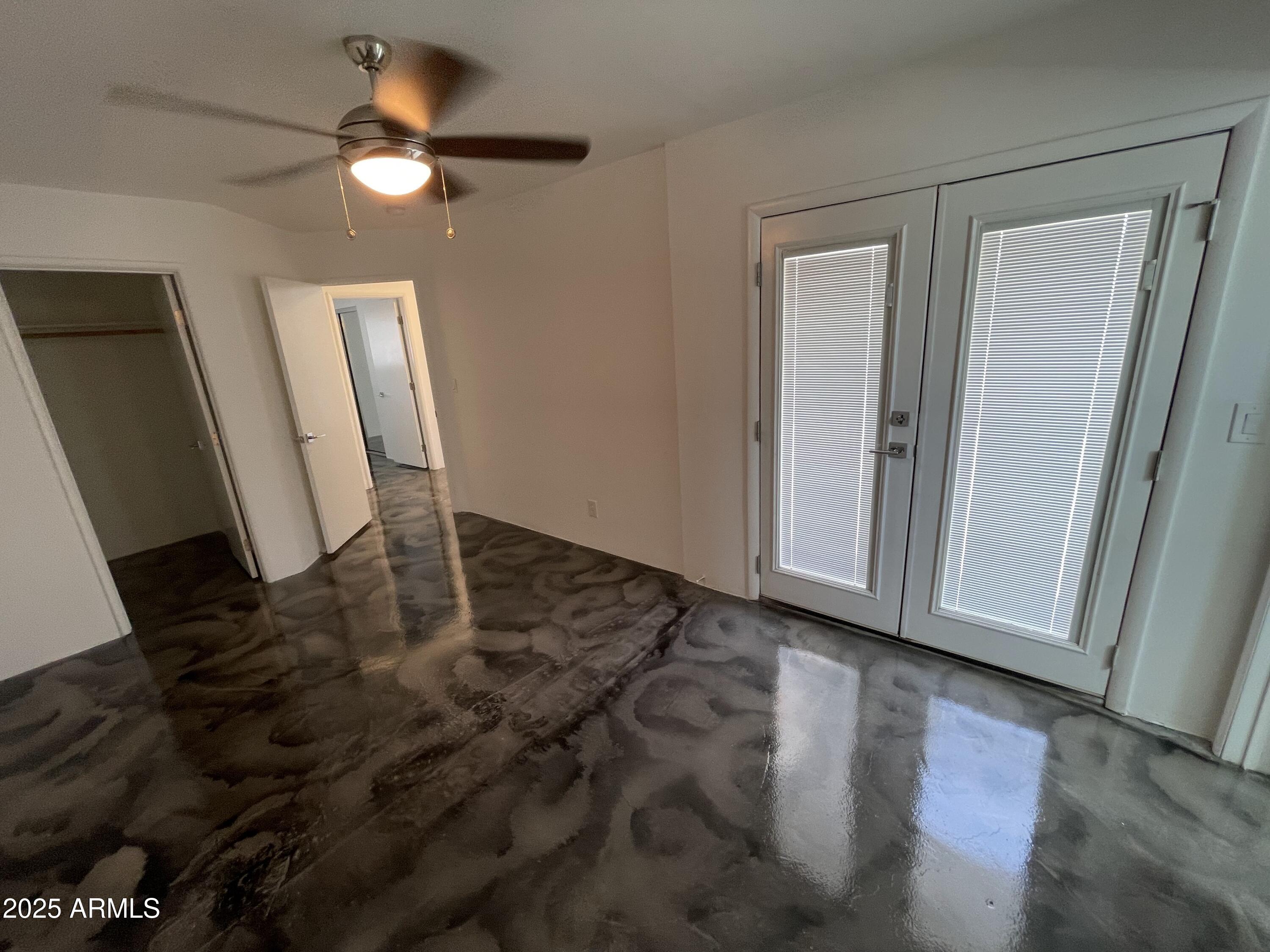 3416 North 37th Street, Unit 3 Phoenix, AZ 85018 - Photo 12 of 22 a view of an empty room with wooden floor and a mirror