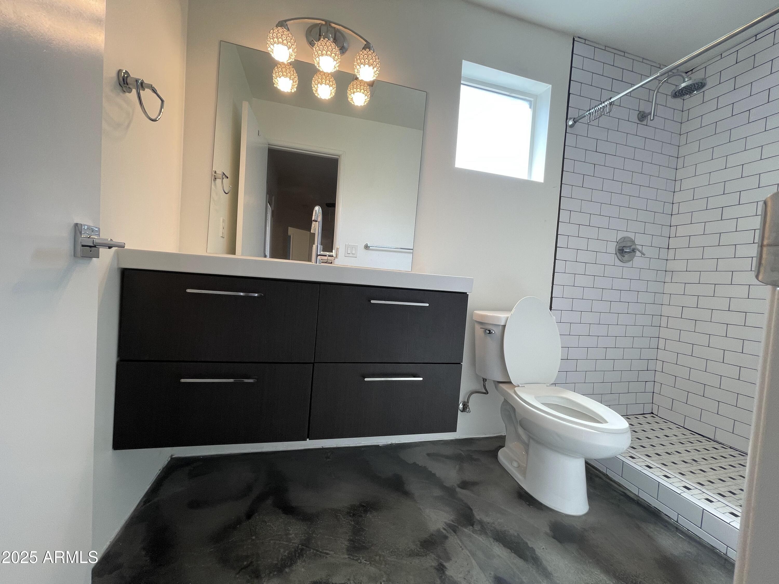 3416 North 37th Street, Unit 3 Phoenix, AZ 85018 - Photo 13 of 22 a bathroom with a toilet a sink and mirror