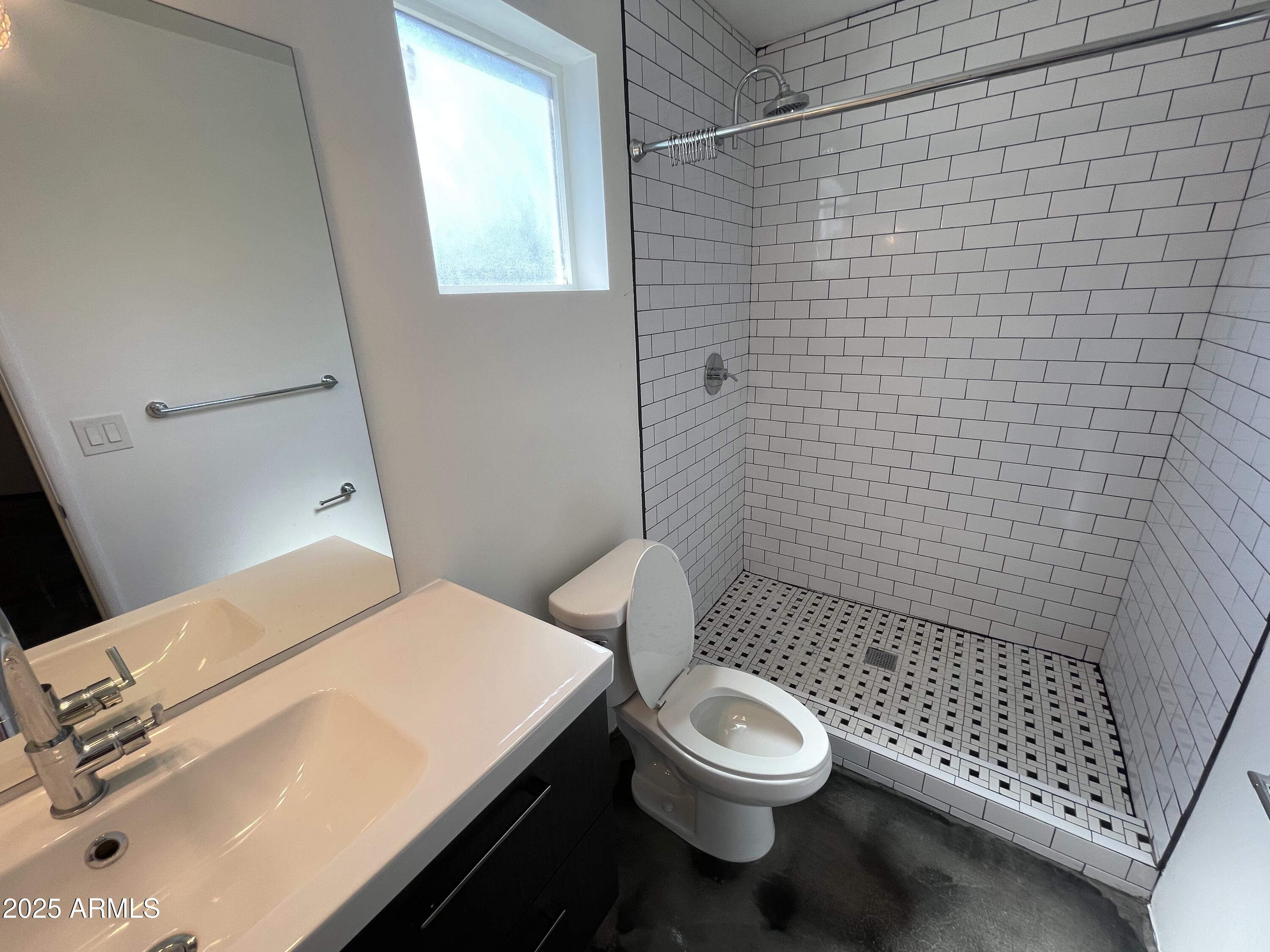 3416 North 37th Street, Unit 3 Phoenix, AZ 85018 - Photo 14 of 22 a bathroom with a sink a toilet and shower