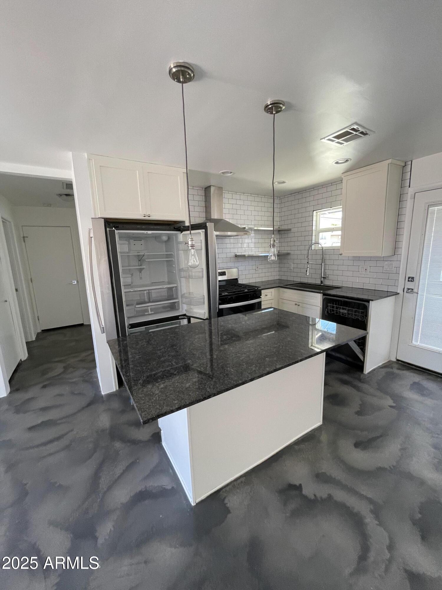 3416 North 37th Street, Unit 3 Phoenix, AZ 85018 - Photo 15 of 22 a view of a kitchen with kitchen island a sink a counter space and wooden floor