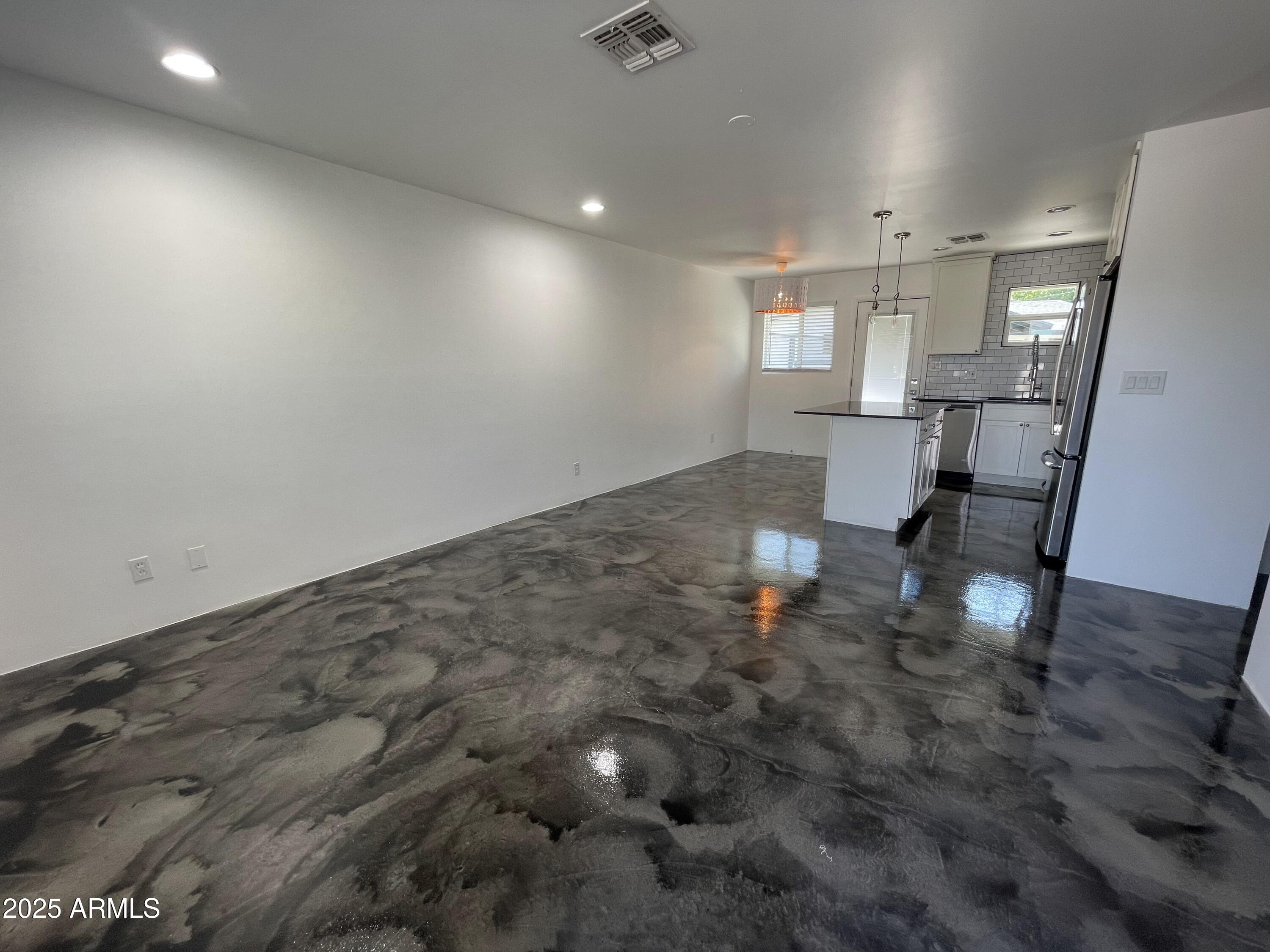 3416 North 37th Street, Unit 3 Phoenix, AZ 85018 - Photo 20 of 22 an empty room with wooden floor and windows