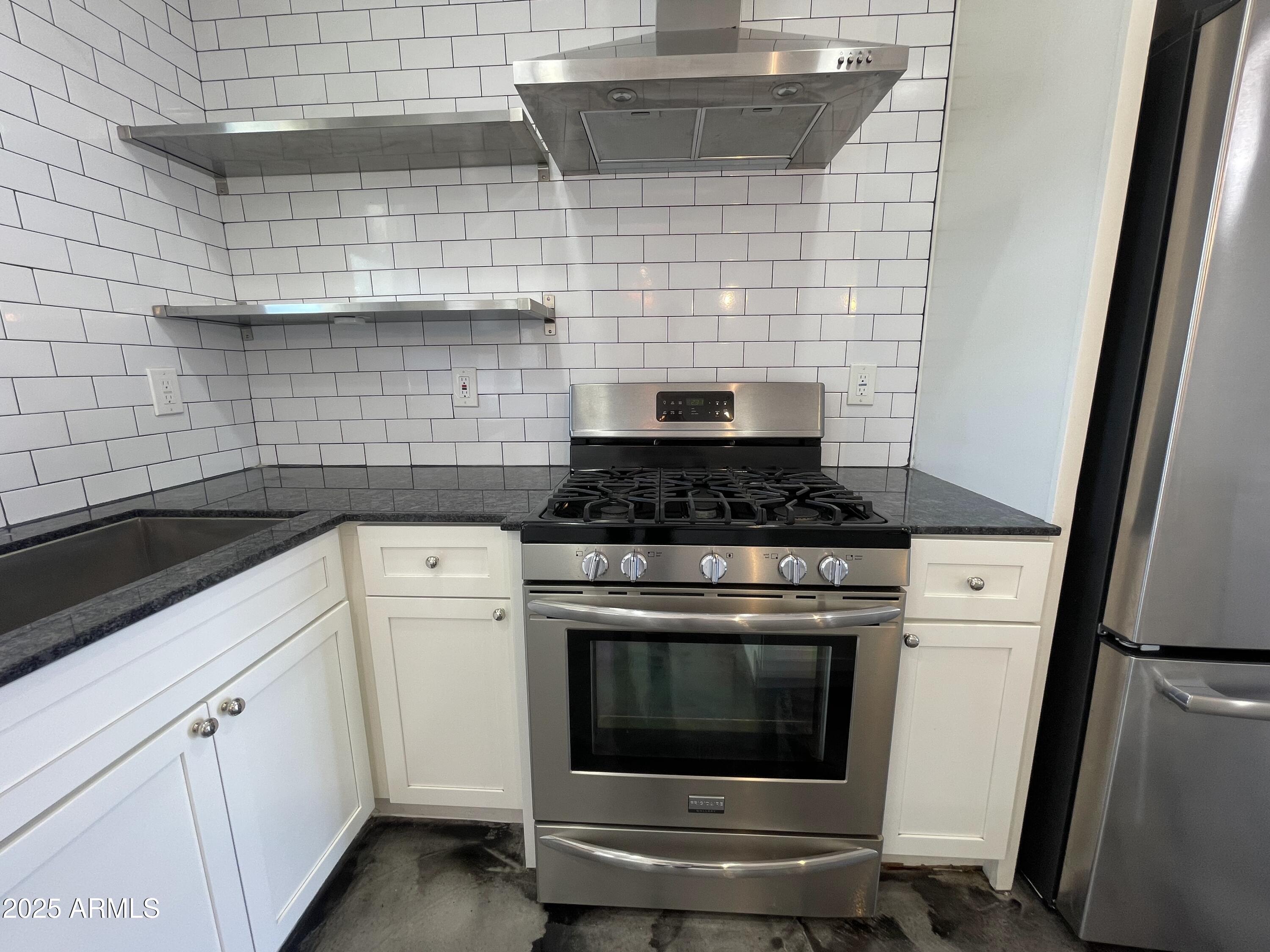 3416 North 37th Street, Unit 3 Phoenix, AZ 85018 - Photo 2 of 22 a stove top oven sitting inside of a kitchen