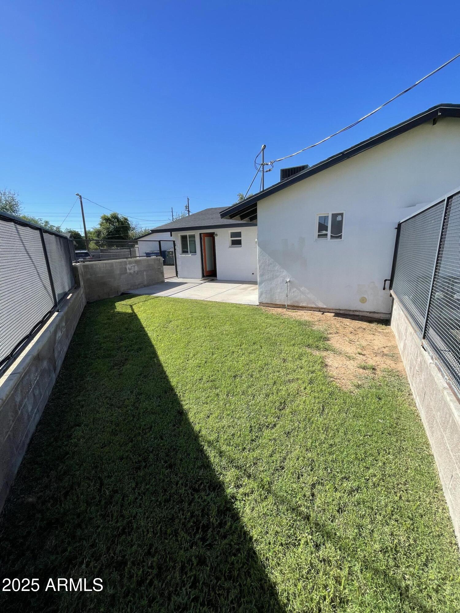 3416 North 37th Street, Unit 3 Phoenix, AZ 85018 - Photo 4 of 22 a backyard of a house with table and chairs