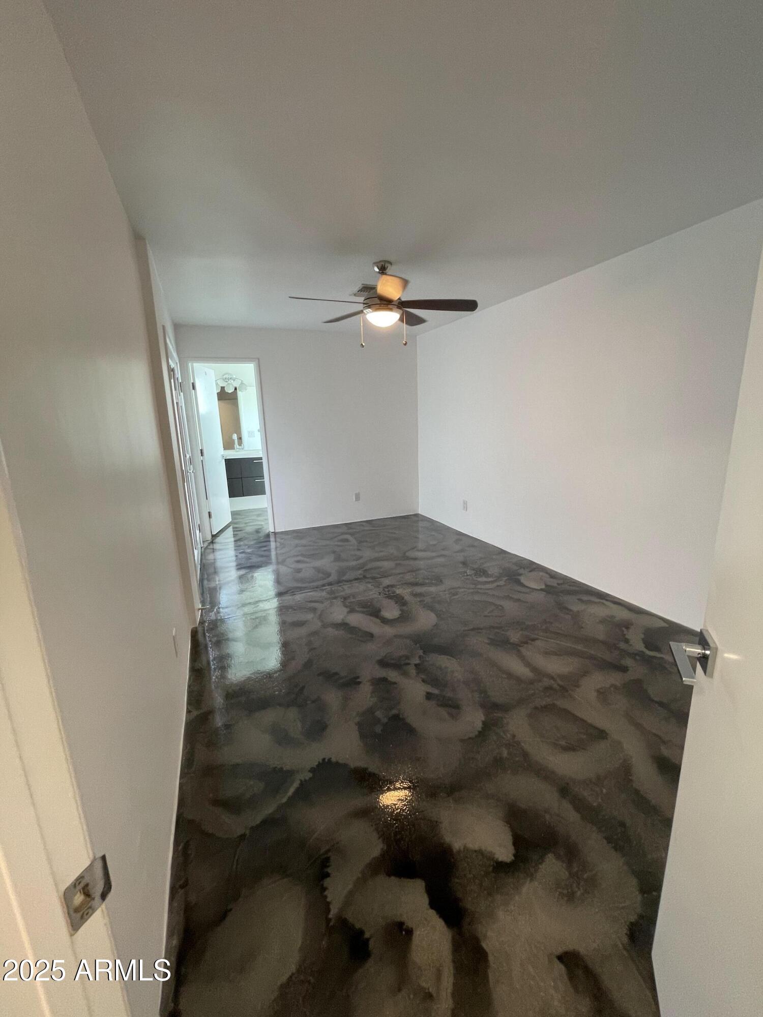 3416 North 37th Street, Unit 3 Phoenix, AZ 85018 - Photo 10 of 22 an empty room with wooden floor and fan