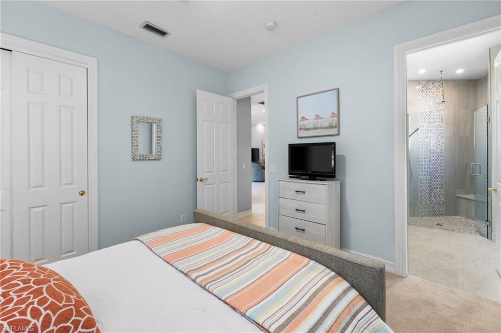 20196 Markward Crossing Estero, FL 33928 - Photo 21 of 42 a bedroom with a bed and a flat screen tv