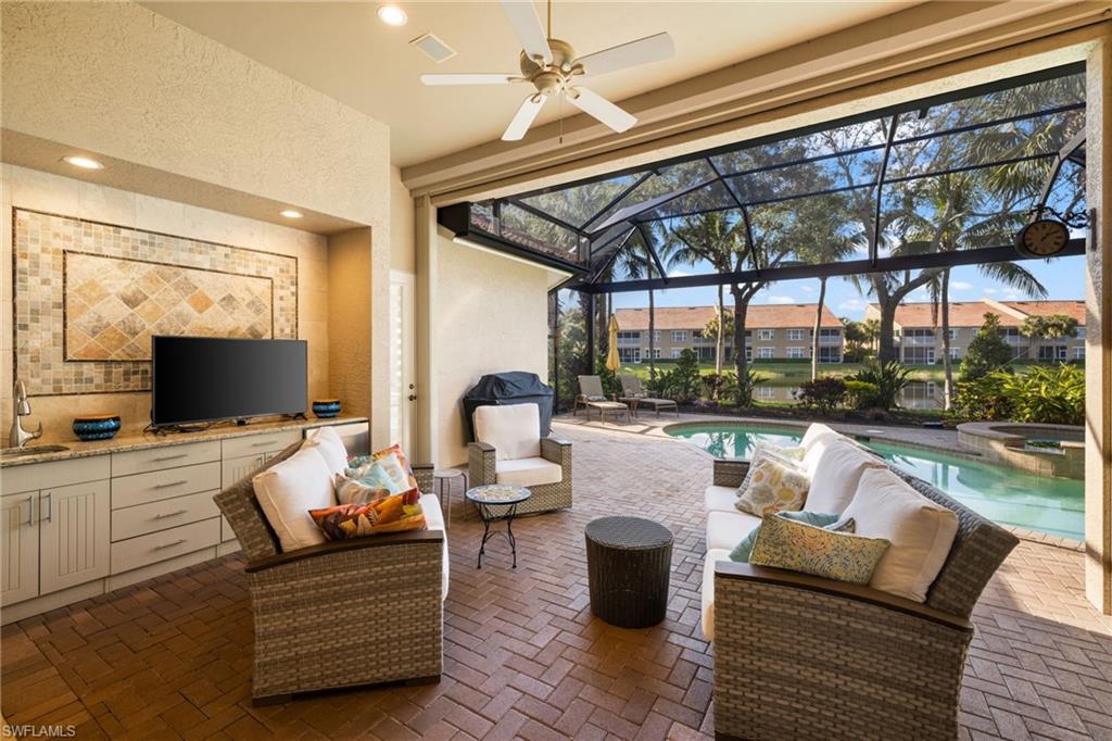 20196 Markward Crossing Estero, FL 33928 - Photo 26 of 42 a living room with patio furniture and a flat screen tv