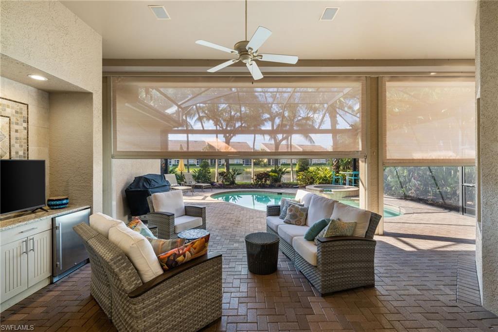 20196 Markward Crossing Estero, FL 33928 - Photo 27 of 42 a living room with patio furniture and a floor to ceiling window