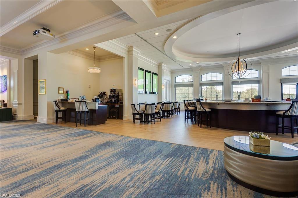 20196 Markward Crossing Estero, FL 33928 - Photo 40 of 42 a living room with furniture a dining table and a chandelier