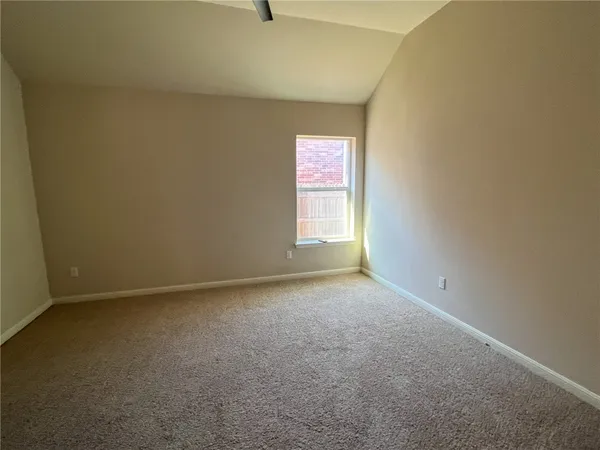 a view of an empty room and a window