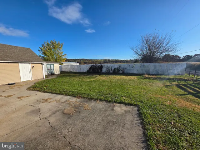 a view of a lake with a house in the background