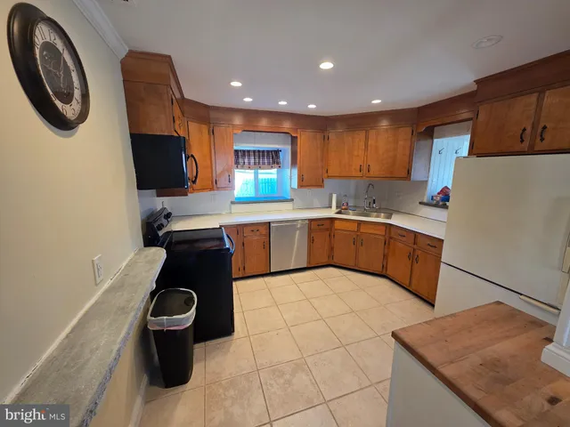 a kitchen with a sink appliances and cabinets