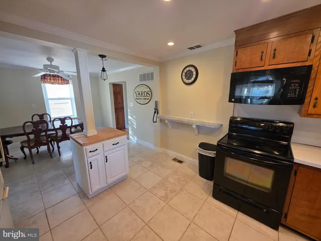 a kitchen with stainless steel appliances granite countertop a stove and a microwave