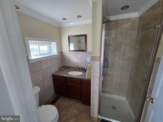 a bathroom with a toilet sink and shower