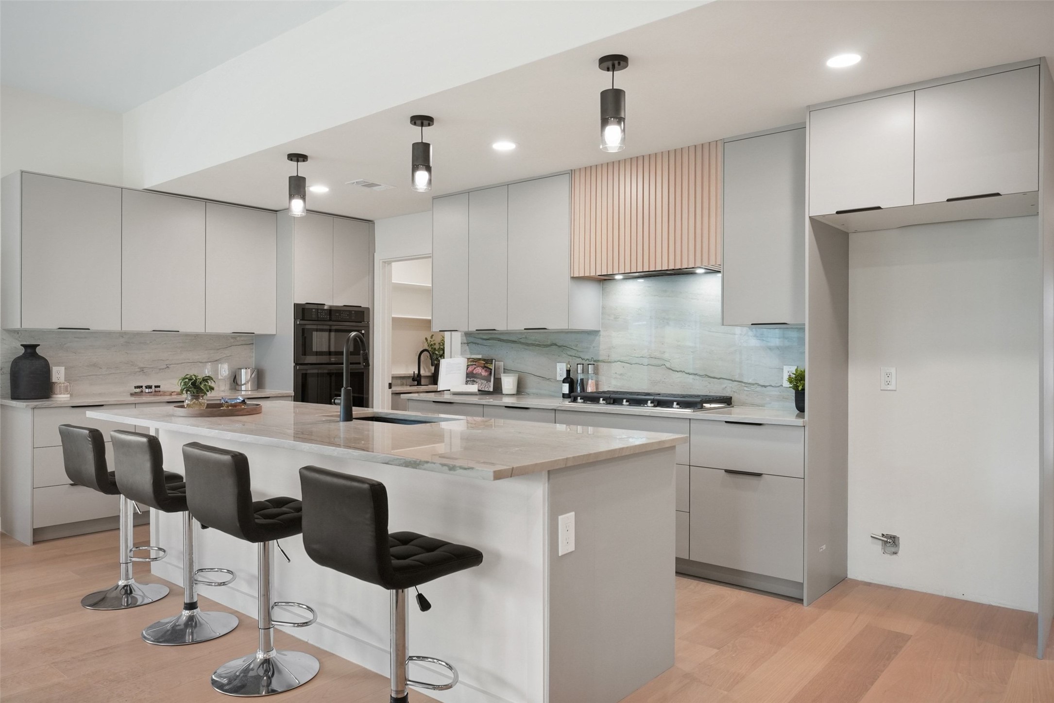 6307 Clubway Lane Austin, TX 78745 - Photo 15 of 34 a kitchen with kitchen island a stove a refrigerator and a stove with wooden floor