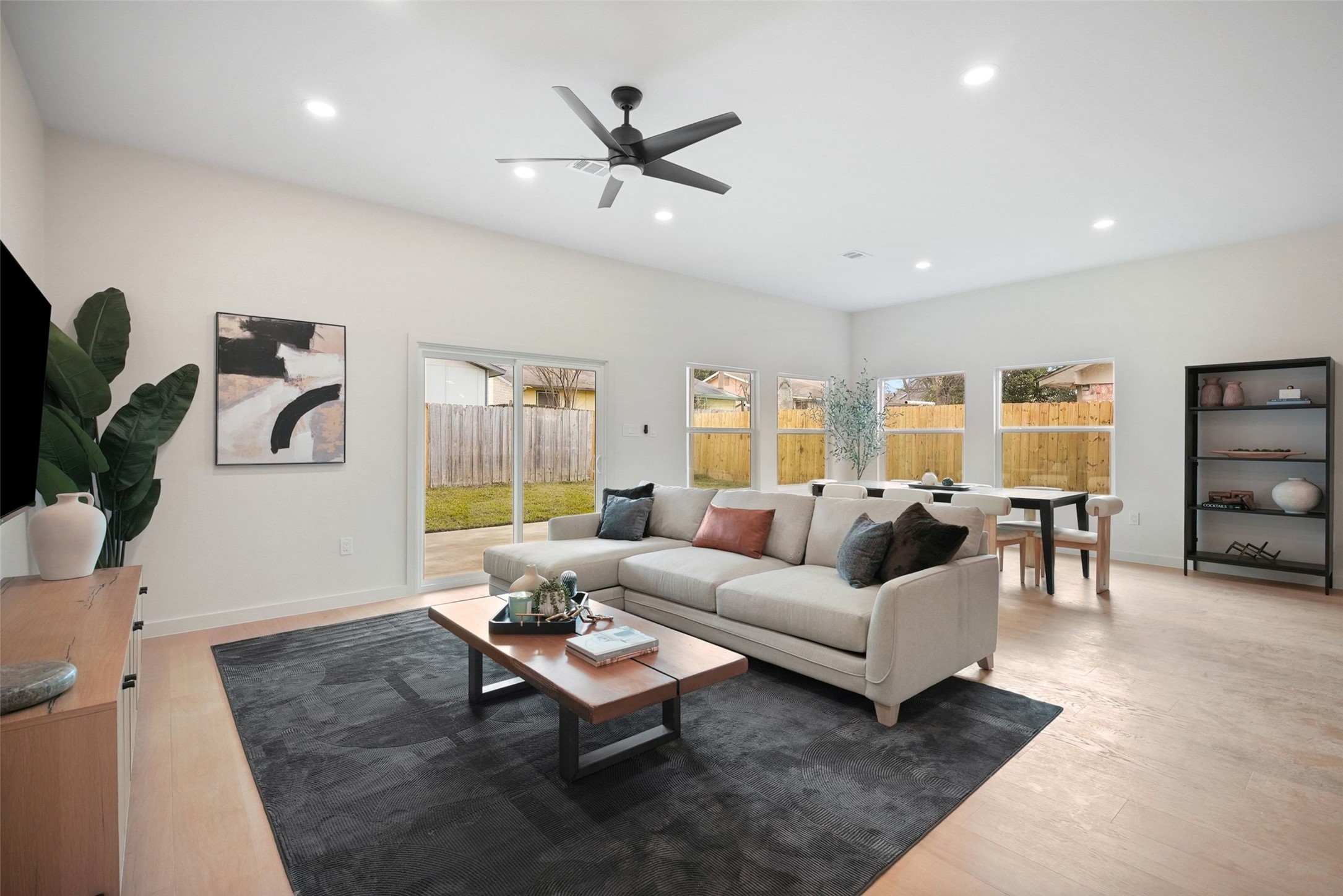 6307 Clubway Lane Austin, TX 78745 - Photo 19 of 34 a living room with furniture a ceiling fan and a window