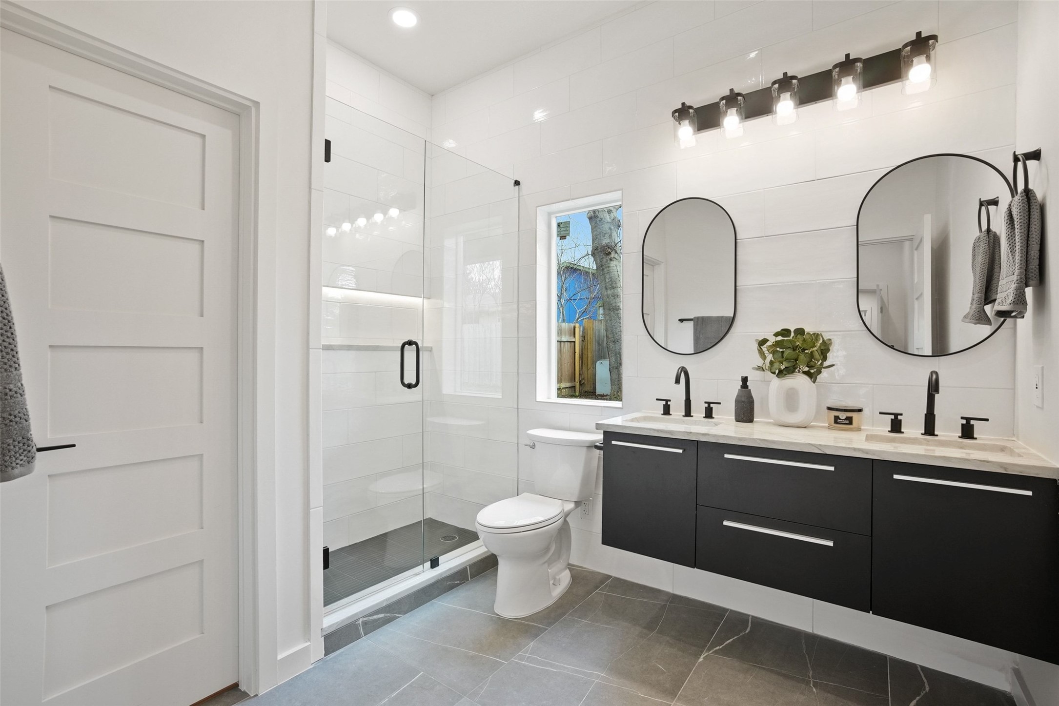 6307 Clubway Lane Austin, TX 78745 - Photo 22 of 34 a bathroom with a double vanity sink mirror and toilet