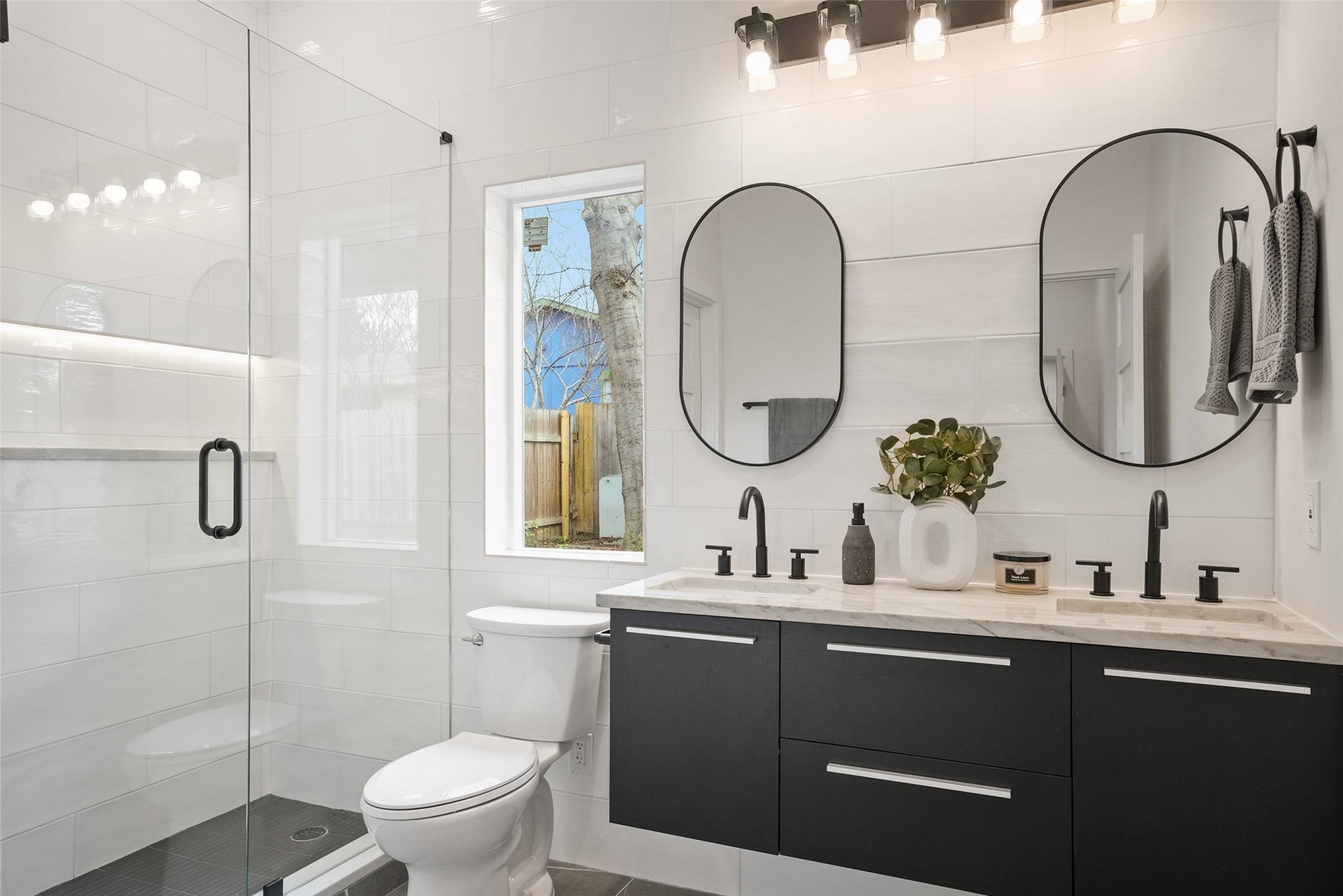 6307 Clubway Lane Austin, TX 78745 - Photo 23 of 34 a bathroom with a toilet a sink and a mirror